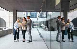 Business professionals talking in a modern office building.