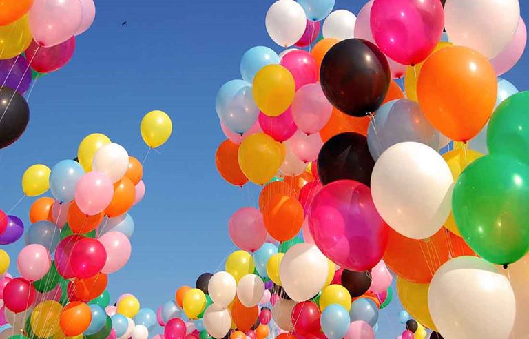 Balloons floating up into the sky.