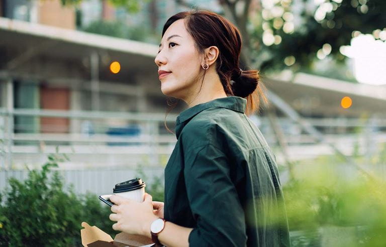 Business professional in casual clothes having a cup of coffee.