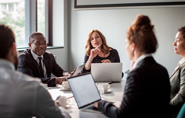 Businesspeople meeting and discussing in a conference room.