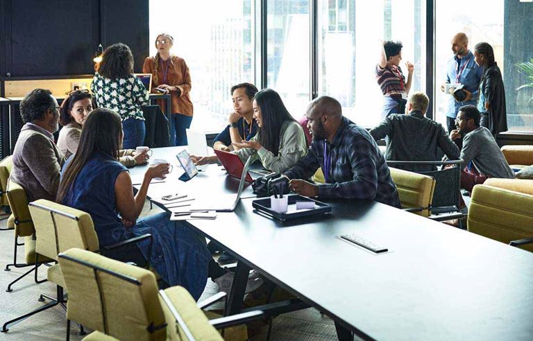 Group of colleagues gathered in a conference room discussing talent development.