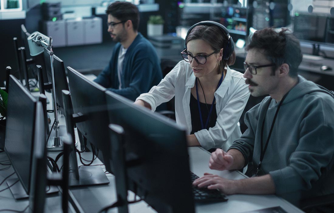 Cybersecurity professionals looking at their computer screen.