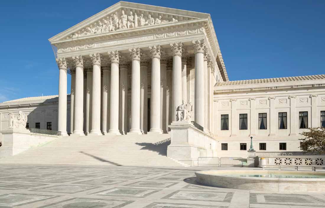 View of U.S. government building against a clear blue sky.