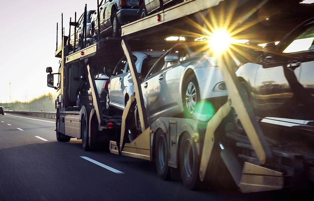 Cars being transported on a highway.