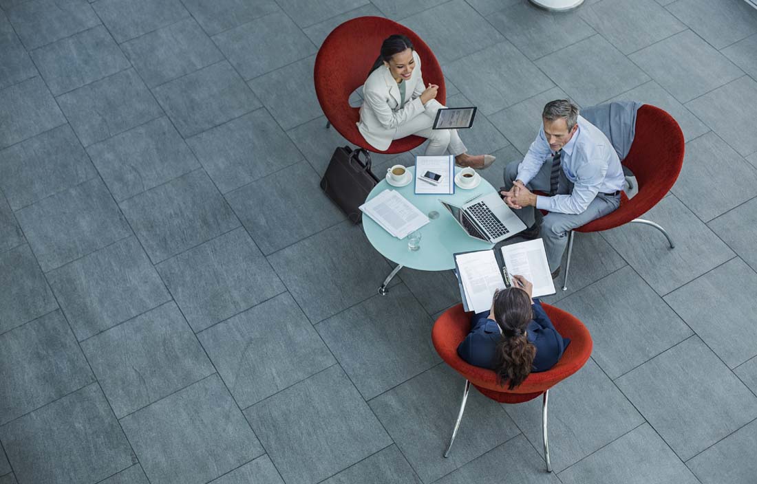 Overhead view of business professionals meeting at a table.