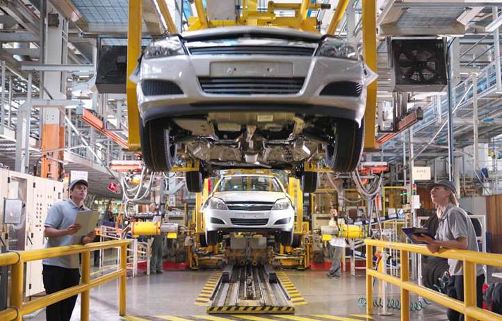 Automobile being assembled in a factory.