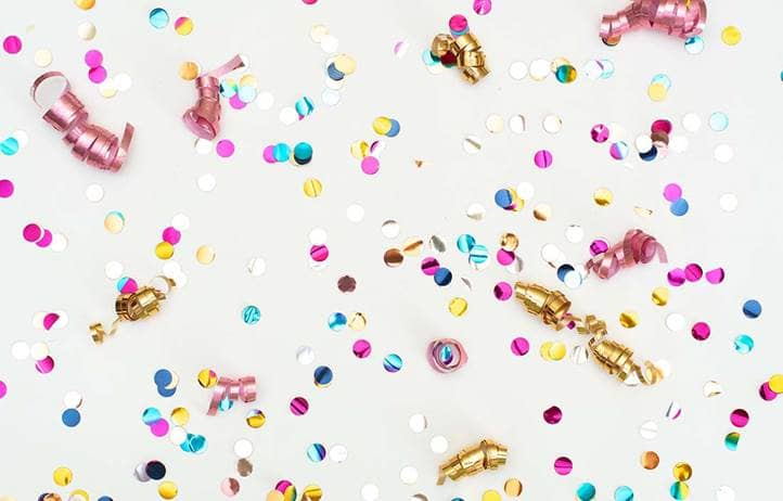 A close up of celebration confetti with a white background