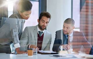 Group of transfer pricing professionals reviewing documents together.