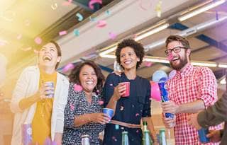 Coworkers celebrating with confetti.