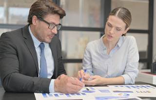 Business professionals discussing AI in a meeting.