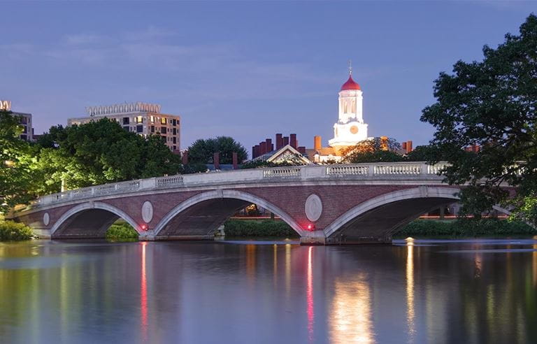 View of Harvard Business School from across a bridge over water