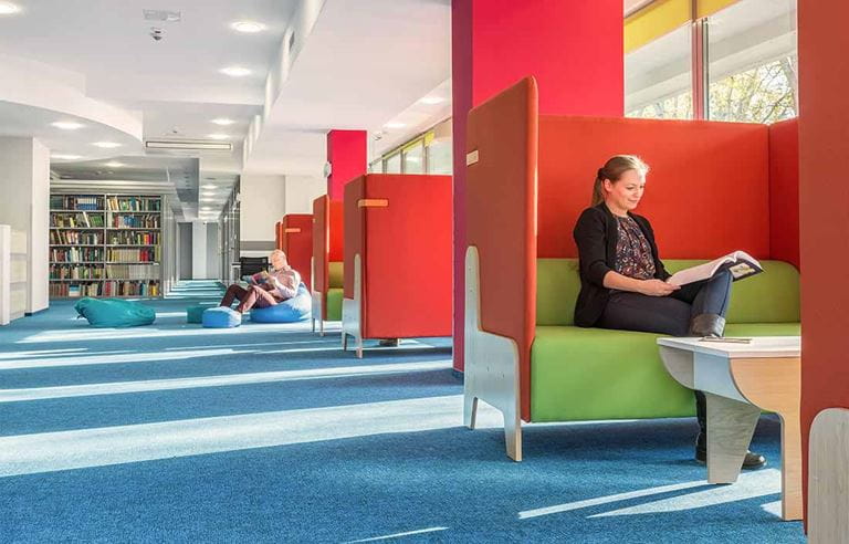 Student sitting in open college library