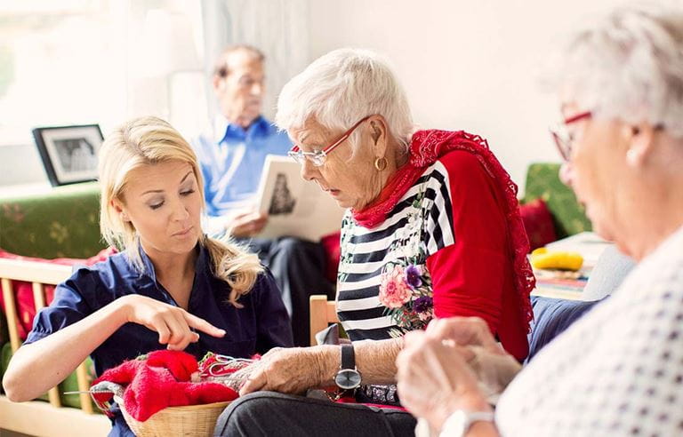 image of care giver helping an elderly woman