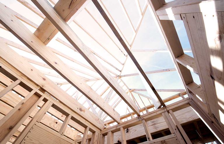 View looking up at the sky through a ceiling of a senior living construction site