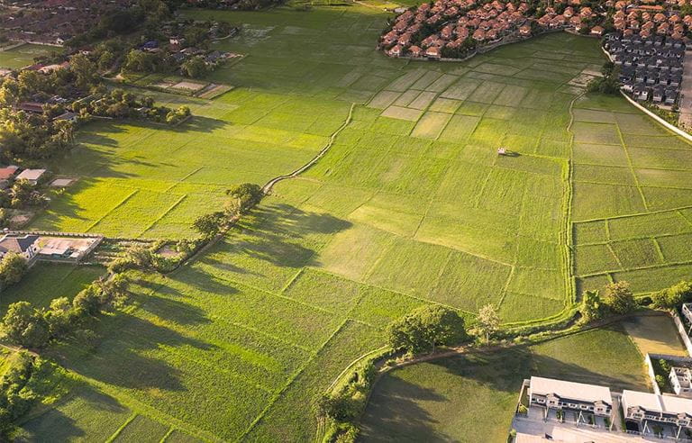 Aerial photo of an open, grassy field in parcels ready for development