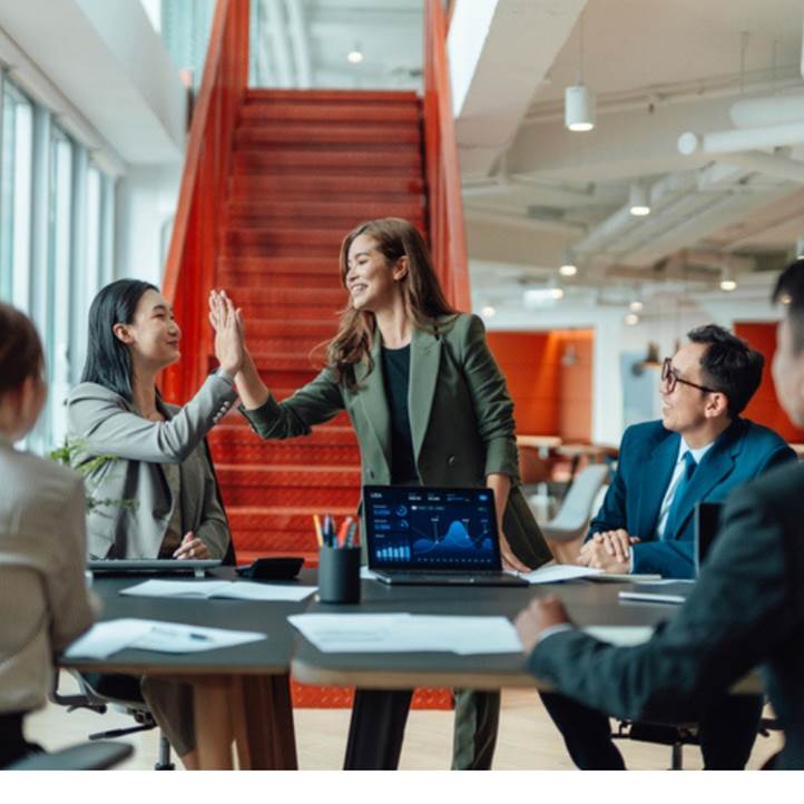 Two business professionals high-fiving.