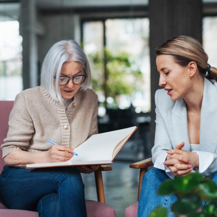 Older adult filling out paperwork.