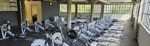 University of Michigan Rowing Association new location's interior showing rowing machines