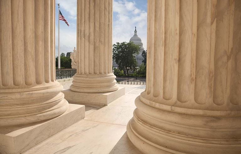 Capitol Building Seen Through Columns of the Unites States Supreme Court Building