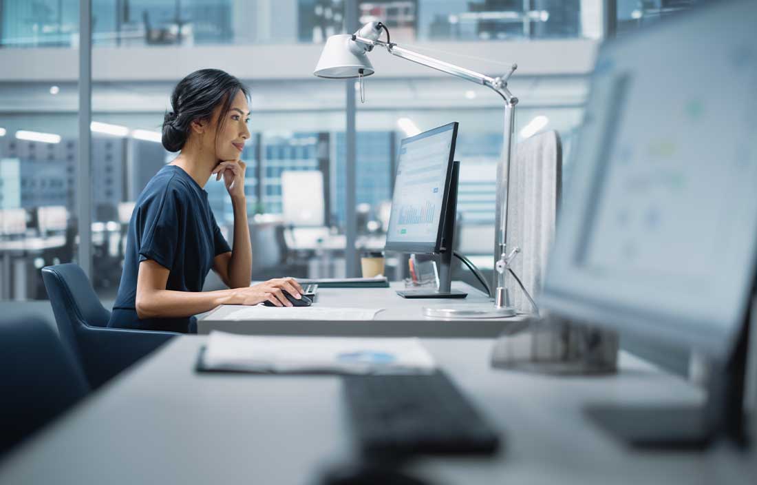 Girl looking at computer looking at Job report data