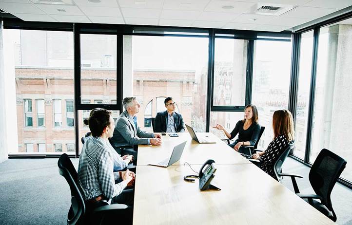 People sitting around a conference table discussing the bond market