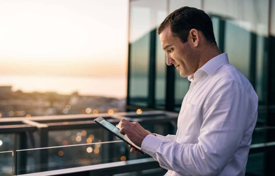 Man looking down at tablet.