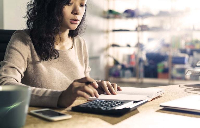 Woman with notepad and calculator