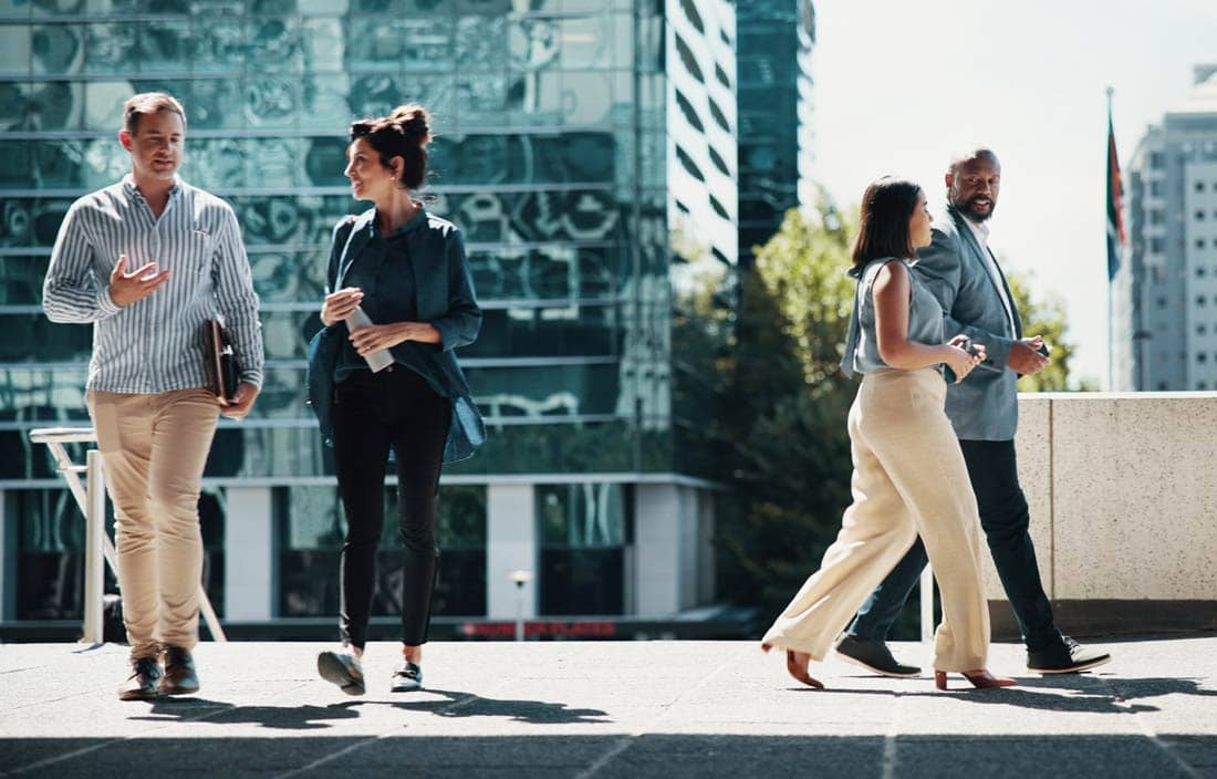 Business professionals walking outside in a plaza